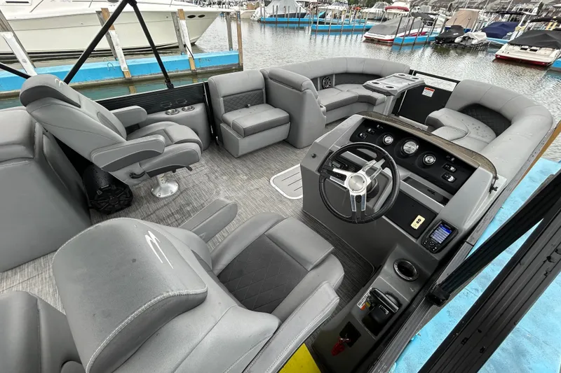 Slide: The Image of Interior of a 2020 Bennington 23 SX pontoon boat with gray seating and steering console. - 6