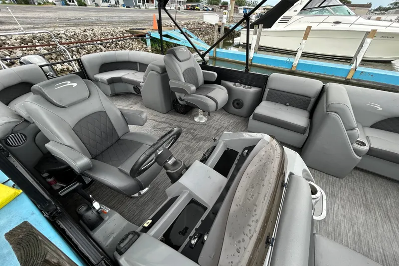 Slide: The Image of Interior of a 2020 Bennington 23 SX boat with gray seating and steering wheel. - 5