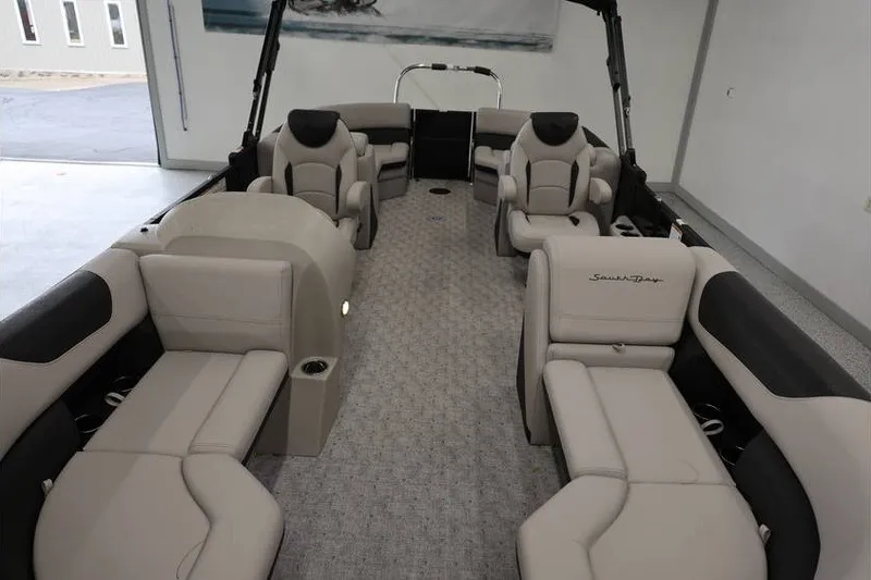 Slide: The Image of 2027 South Bay LE 224 RS 2.75 JAWS Edition pontoon boat interior with beige seating. - 19