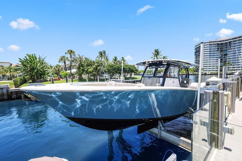 Slide: The Image of 2024 Sportsman Open 352 Center Console boat docked in sunny marina setting. - 41