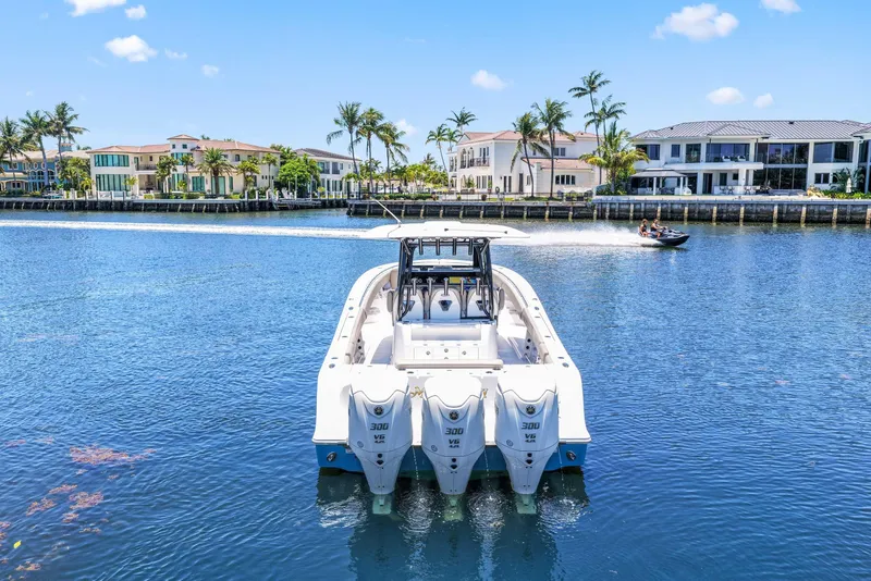 Slide: The Image of 2024 Sportsman Open 352 Center Console boat on a sunny waterfront. - 5