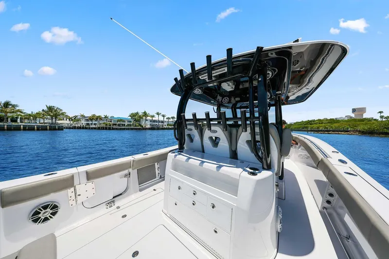 Slide: The Image of 2024 Sportsman Open 352 Center Console boat on calm water, clear sky background. - 19