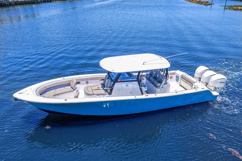 Slide: The Image of 2024 Sportsman Open 352 Center Console boat on calm blue water. - 3