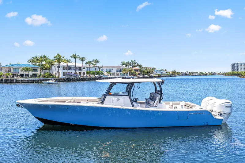 The Image of 2024 Sportsman Open 352 Center Console boat on a sunny waterfront. - 0