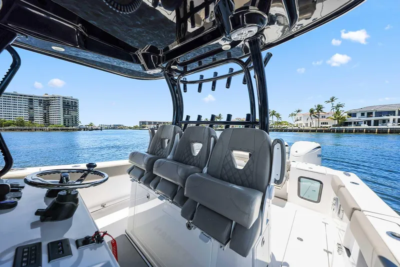 Slide: The Image of 2024 Sportsman Open 352 Center Console boat interior with luxurious seating and waterfront view. - 13