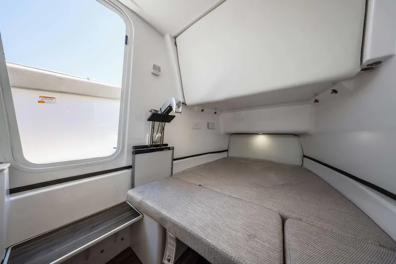Slide: The Image of 2024 Sportsman Open 352 Center Console cabin interior with bed and window view. - 39