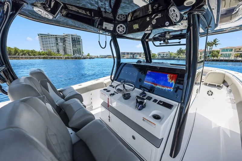 Slide: The Image of 2024 Sportsman Open 352 Center Console boat interior with advanced navigation system on a sunny day. - 26