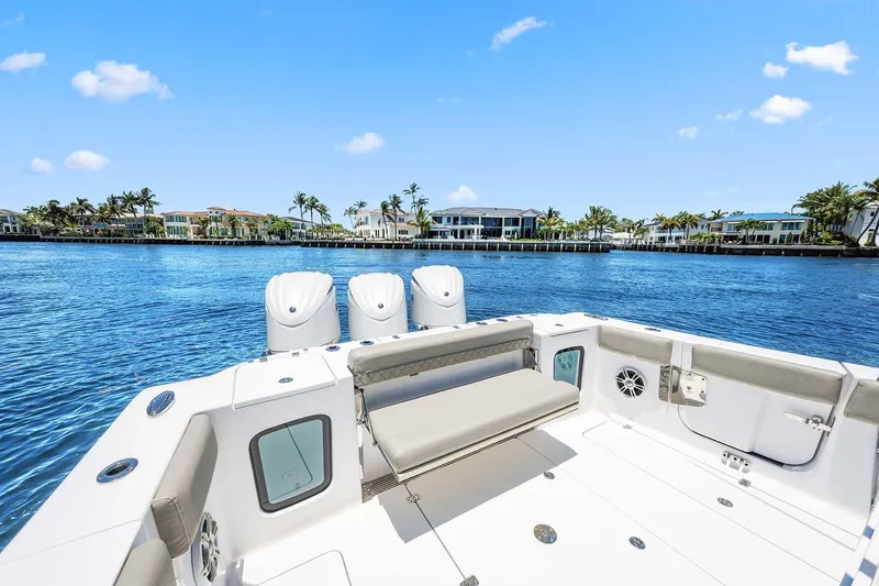 Slide: The Image of 2024 Sportsman Open 352 Center Console boat on a sunny waterfront. - 15