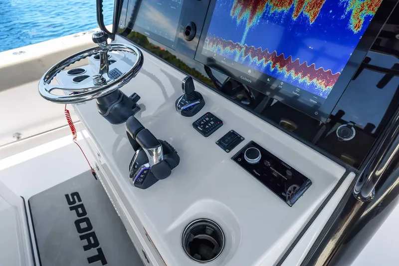 Slide: The Image of 2024 Sportsman Open 352 Center Console dashboard with Garmin display and controls. - 27