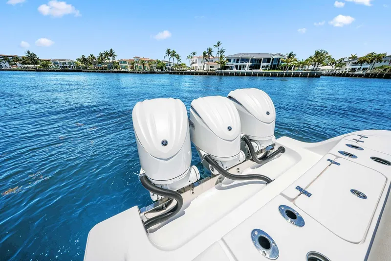 Slide: The Image of 2024 Sportsman Open 352 Center Console with triple engines on blue water. - 16