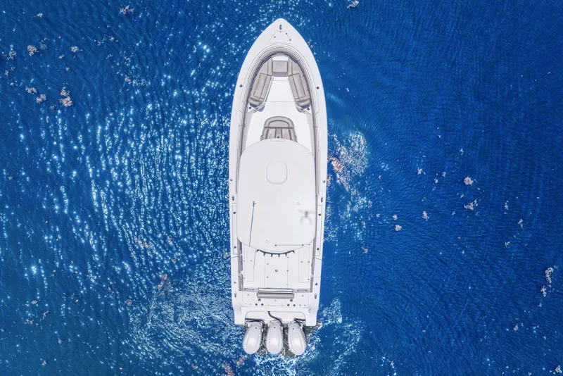 Slide: The Image of 2024 Sportsman Open 352 Center Console boat on sparkling blue ocean. - 10