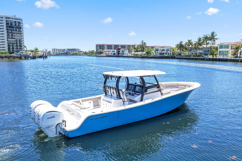 Slide: The Image of 2024 Sportsman Open 352 Center Console boat on a sunny waterfront. - 7