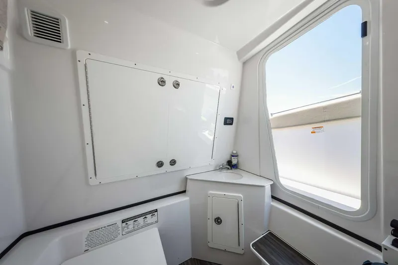 Slide: The Image of 2024 Sportsman Open 352 Center Console interior with storage and window view. - 40
