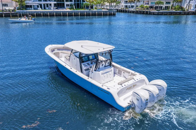 Slide: The Image of 2024 Sportsman Open 352 Center Console boat cruising on a sunny waterfront. - 4