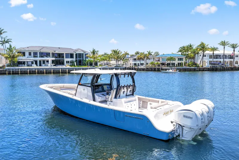 Slide: The Image of 2024 Sportsman Open 352 Center Console boat on water, with luxury waterfront homes in background. - 2