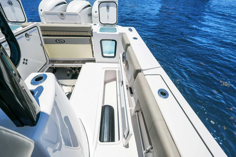 Slide: The Image of 2024 Sportsman Open 352 Center Console boat deck with seating and storage, on blue water. - 23