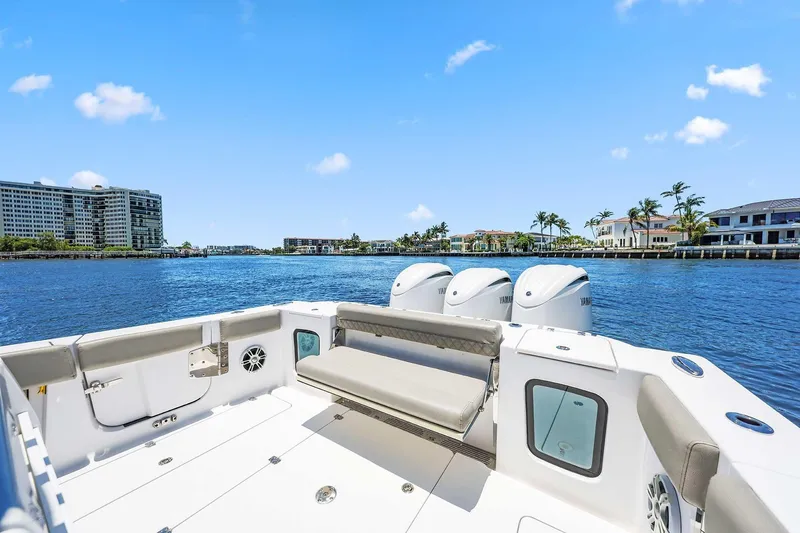 Slide: The Image of 2024 Sportsman Open 352 Center Console boat on a sunny waterfront. - 14