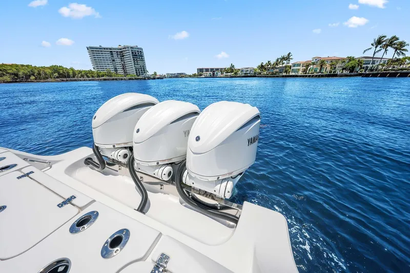 Slide: The Image of 2024 Sportsman Open 352 Center Console with triple Yamaha outboard engines on blue water. - 17