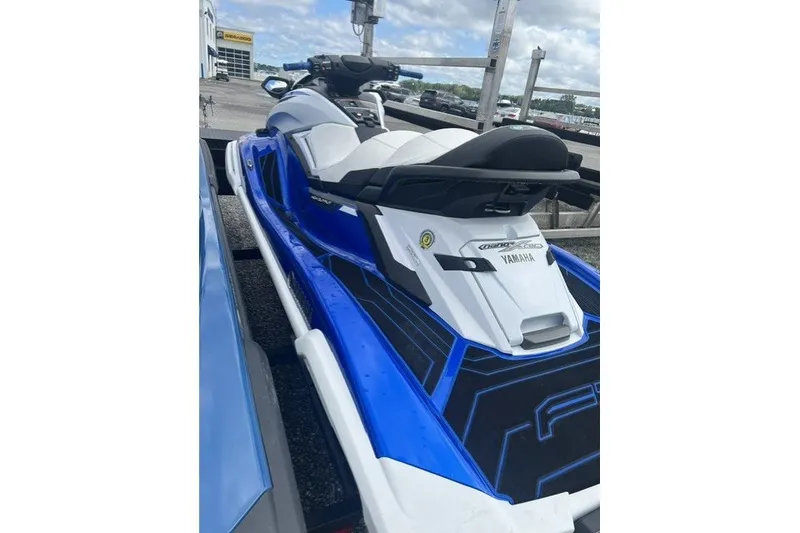 Slide: The Image of 2021 Yamaha WaveRunner FX Cruiser HO in blue and white, parked outdoors. - 2