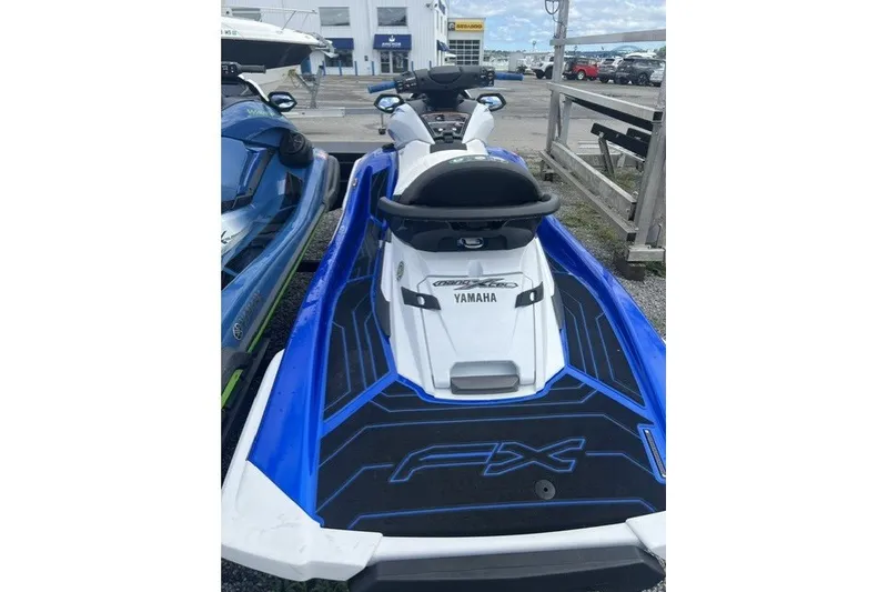 Slide: The Image of 2021 Yamaha WaveRunner FX Cruiser HO in blue and white, parked outdoors. - 1