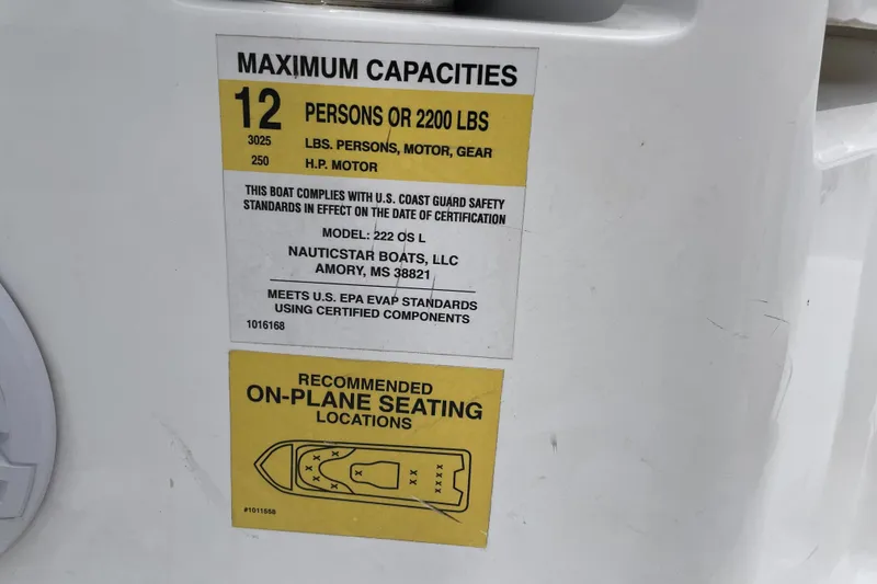 Slide: The Image of 2024 NauticStar 222L Offshore capacity label, 12 persons or 2200 lbs, safety compliance. - 7