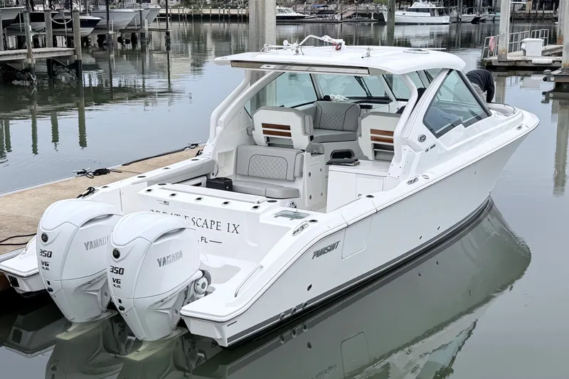 Slide: The Image of 2025 Pursuit DC 326 Dual Console boat docked with twin Yamaha engines. - 1