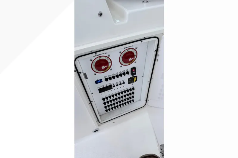 Slide: The Image of Control panel of 2025 Pursuit DC 326 Dual Console boat, featuring switches and dials. - 3