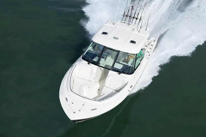 Slide: The Image of Manufacturer Provided Image: 2025 Pursuit DC 326 Dual Console boat cruising on open water. - 4