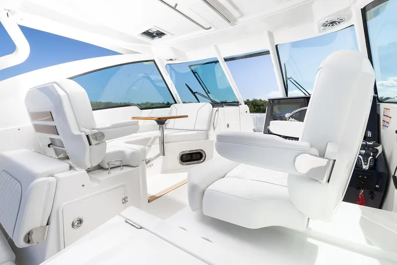 Slide: The Image of Manufacturer Provided Image: Interior of 2025 Pursuit DC 326 Dual Console boat with white seating and modern design. - 10