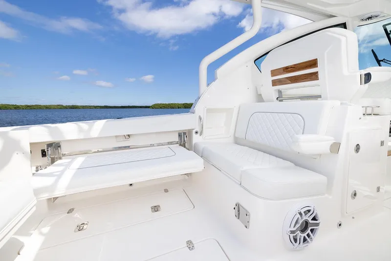 Slide: The Image of Manufacturer Provided Image: 2025 Pursuit DC 326 Dual Console boat interior with white seating and scenic water view. - 11