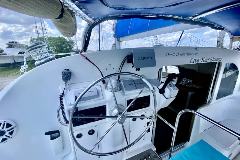 The Image of Cockpit of 2001 Lagoon 410 catamaran with Garmin navigation and motivational quote. - 1