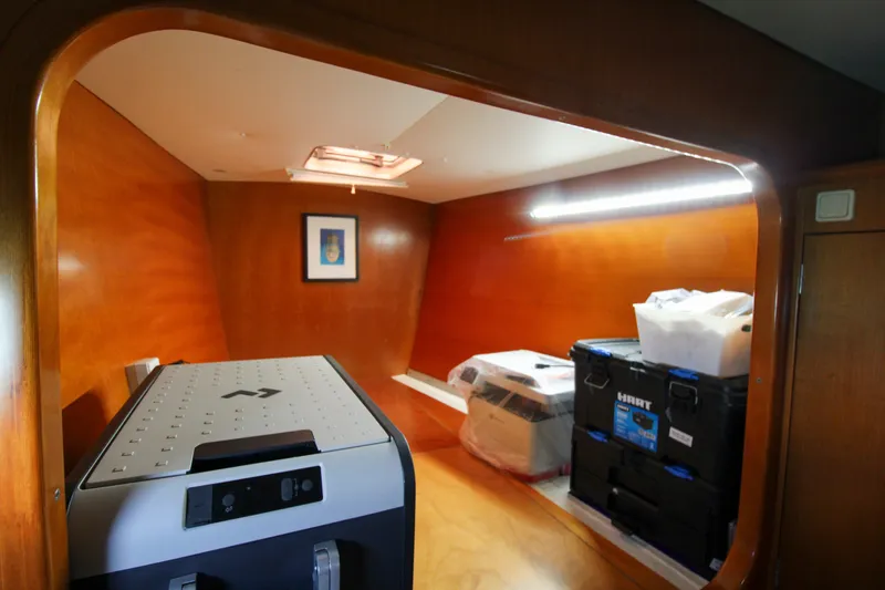 Slide: The Image of Interior of 2001 Lagoon 410 yacht with storage boxes and wooden paneling. - 39