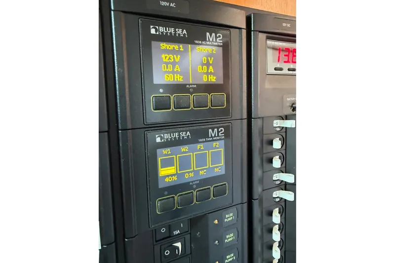 Slide: The Image of Electrical panel on a 2001 Lagoon 410 yacht, featuring Blue Sea Systems displays. - 70