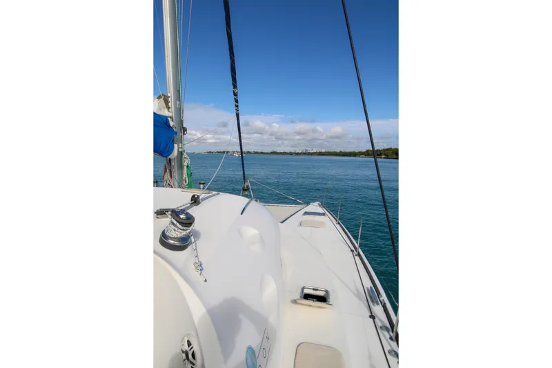 Slide: The Image of Sailing on a 2001 Lagoon 410 catamaran, clear blue waters and sky in view. - 28