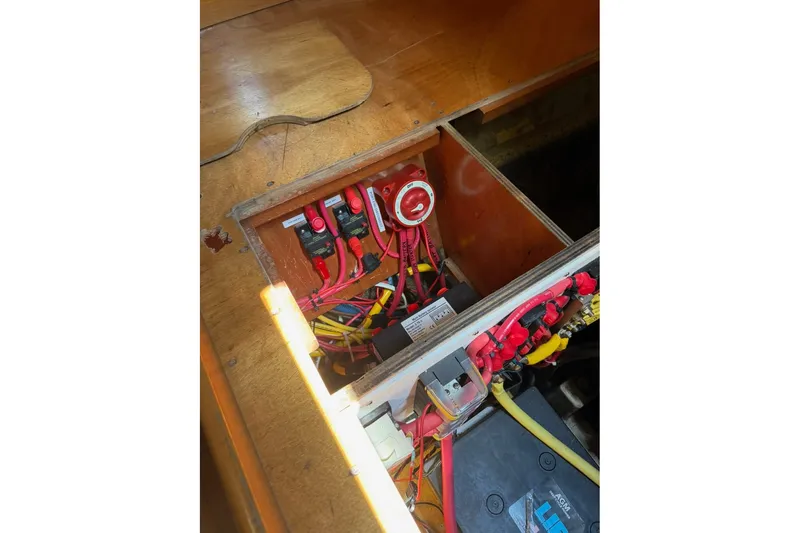 Slide: The Image of Electrical panel inside a 2001 Lagoon 410 boat, featuring wiring and switches. - 65