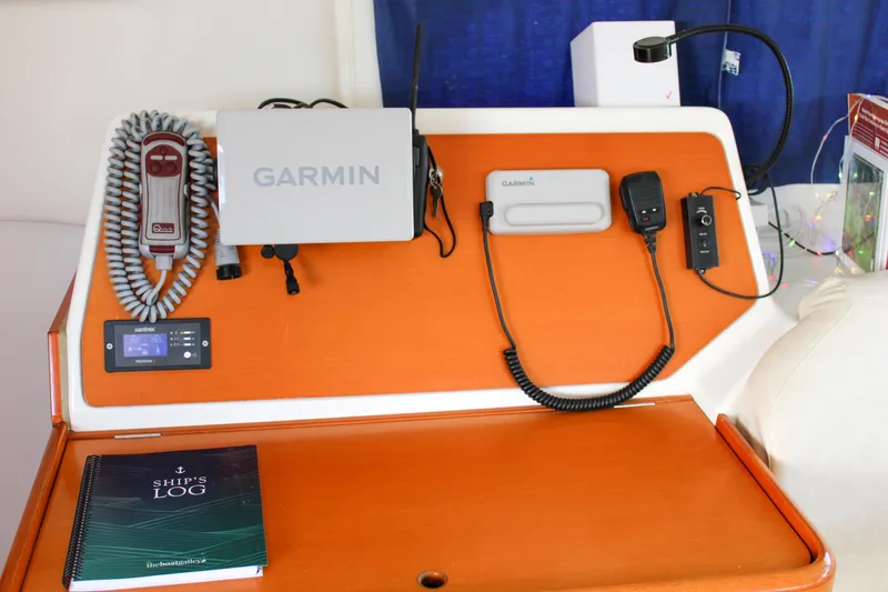 Slide: The Image of Navigation equipment on a 2001 Lagoon 410 catamaran with Garmin devices and ship's log. - 54