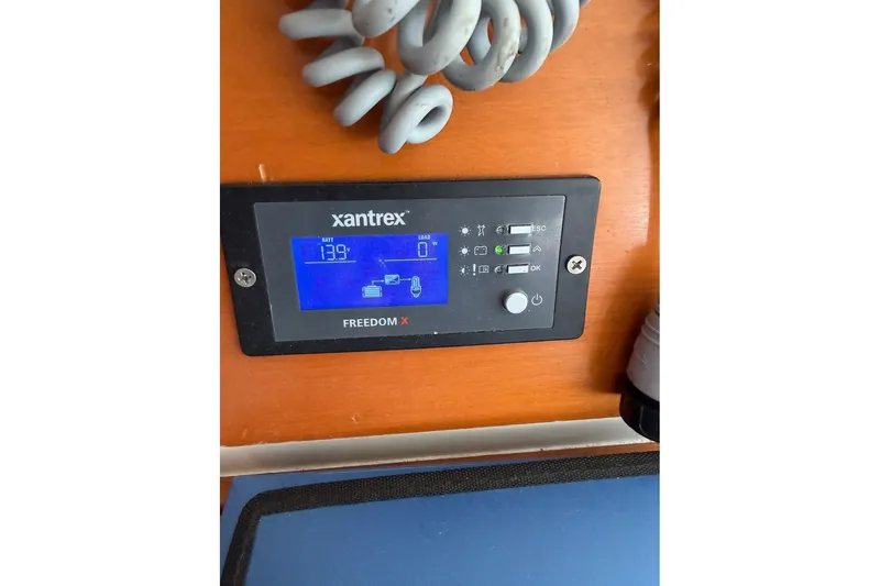 Slide: The Image of Xantrex Freedom X control panel on 2001 Lagoon 410 yacht, displaying battery status. - 71