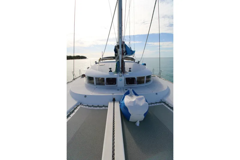 Slide: The Image of Front deck of a 2001 Lagoon 410 catamaran sailing on calm waters. - 22