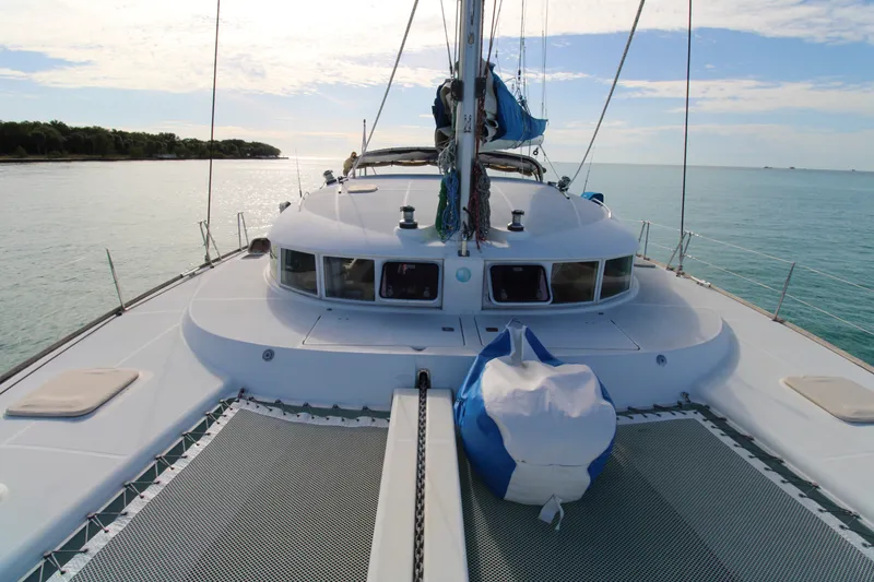 Slide: The Image of Lagoon 410 catamaran sailing on calm sea, 2001 model, sunny day. - 23