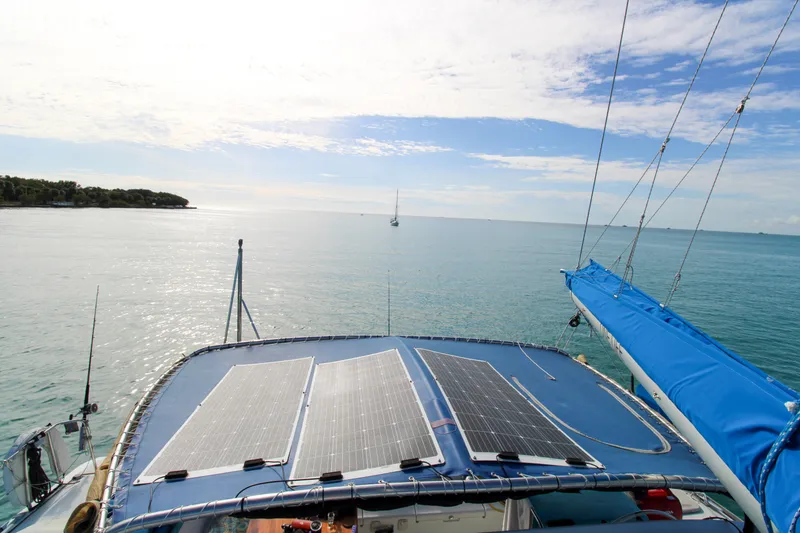 Slide: The Image of Lagoon 410 catamaran with solar panels, sailing on a serene ocean, 2001 model. - 27