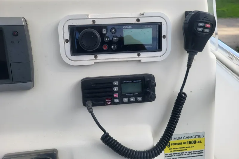 Slide: The Image of 2012 Cobia 217 Center Console dashboard with radio and communication equipment. - 24