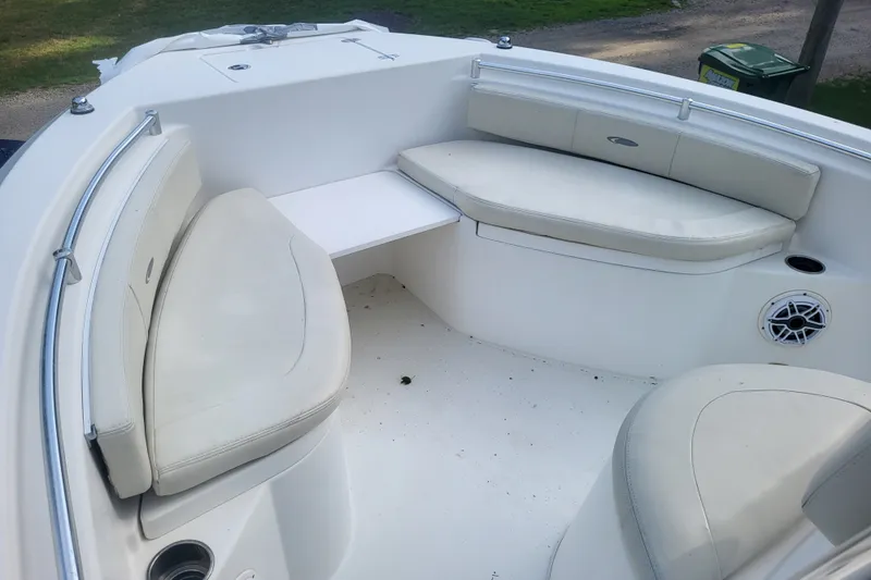 Slide: The Image of 2012 Cobia 217 Center Console boat interior with cushioned seating and speaker. - 32