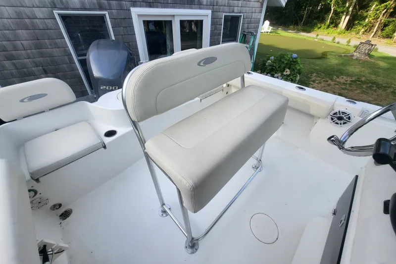 Slide: The Image of 2012 Cobia 217 Center Console boat interior with seating and outboard motor. - 12