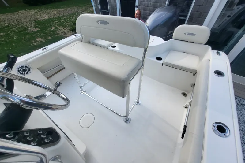 Slide: The Image of 2012 Cobia 217 Center Console boat interior with seating and steering wheel. - 18