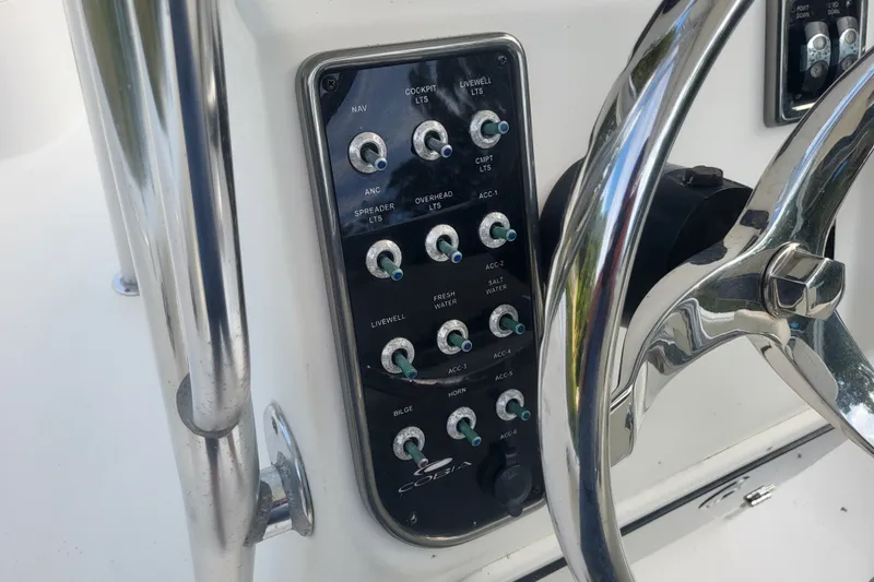 Slide: The Image of Control panel of a 2012 Cobia 217 Center Console boat with steering wheel. - 22