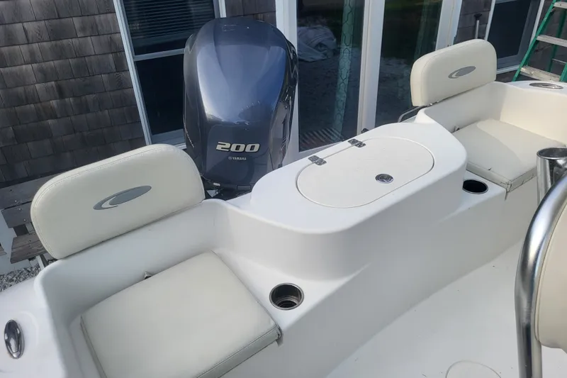 Slide: The Image of 2012 Cobia 217 Center Console boat interior with Yamaha 200 engine. - 9