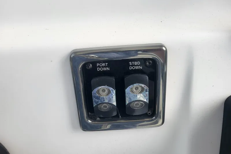 Slide: The Image of Boat control panel with port and starboard switches on a 2012 Cobia 217 Center Console. - 23