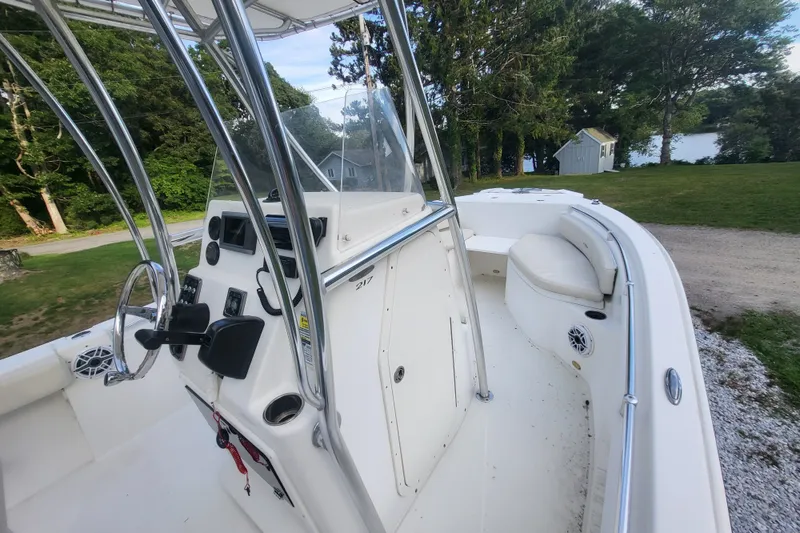 Slide: The Image of 2012 Cobia 217 Center Console boat with sleek design, spacious seating, and modern controls. - 19