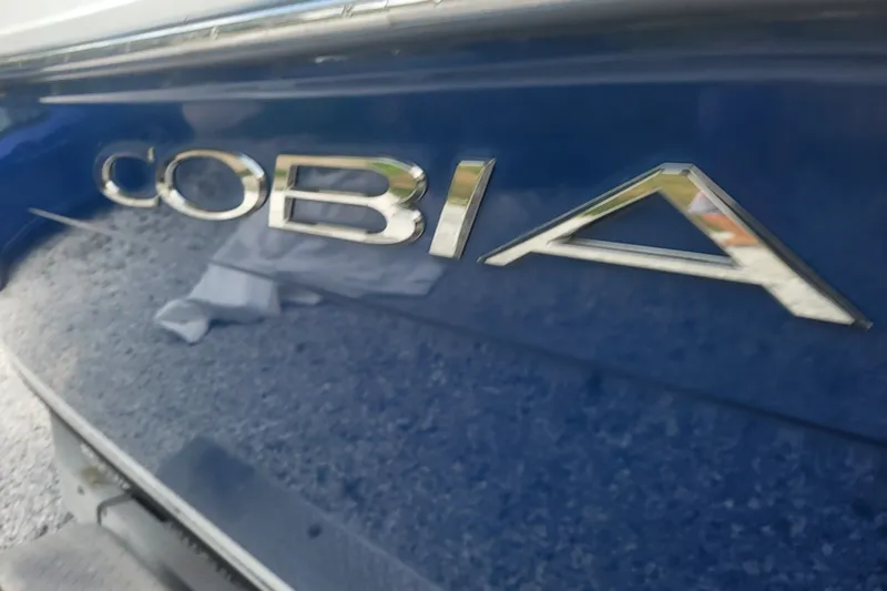 Slide: The Image of 2012 Cobia 217 Center Console boat logo on blue hull. - 5