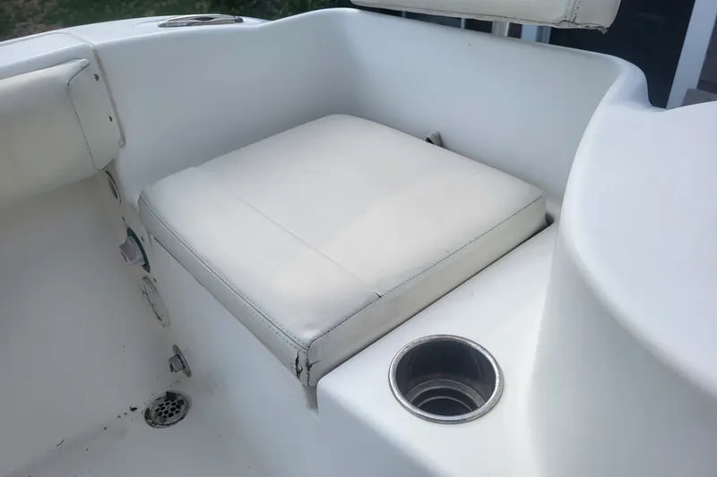 Slide: The Image of Cobia 217 Center Console 2012 boat seat with cup holder and drain. - 28